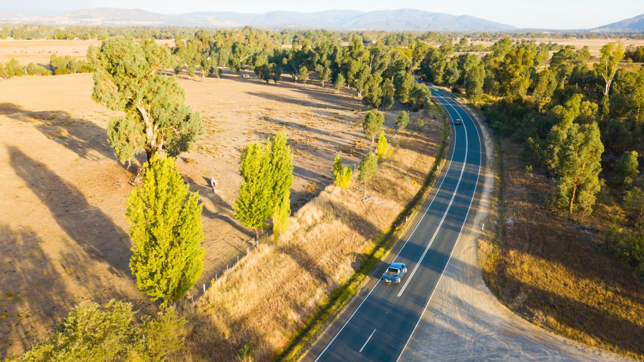 Aerial photo of a car driving along a regional road