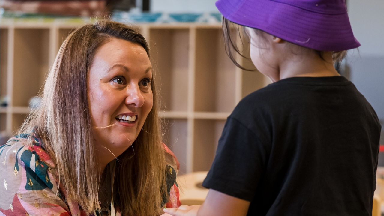 Early childhood education teacher with young student