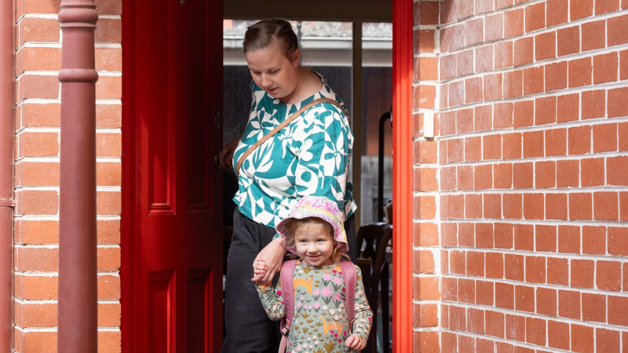 Mother leaving her home with young daughter